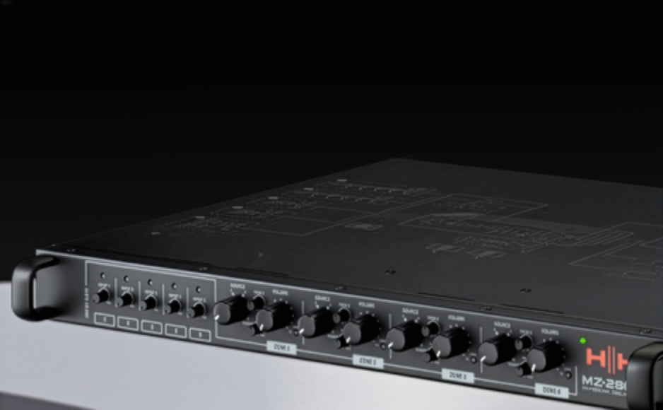 Audio equipment with control knobs and labels on a dark background