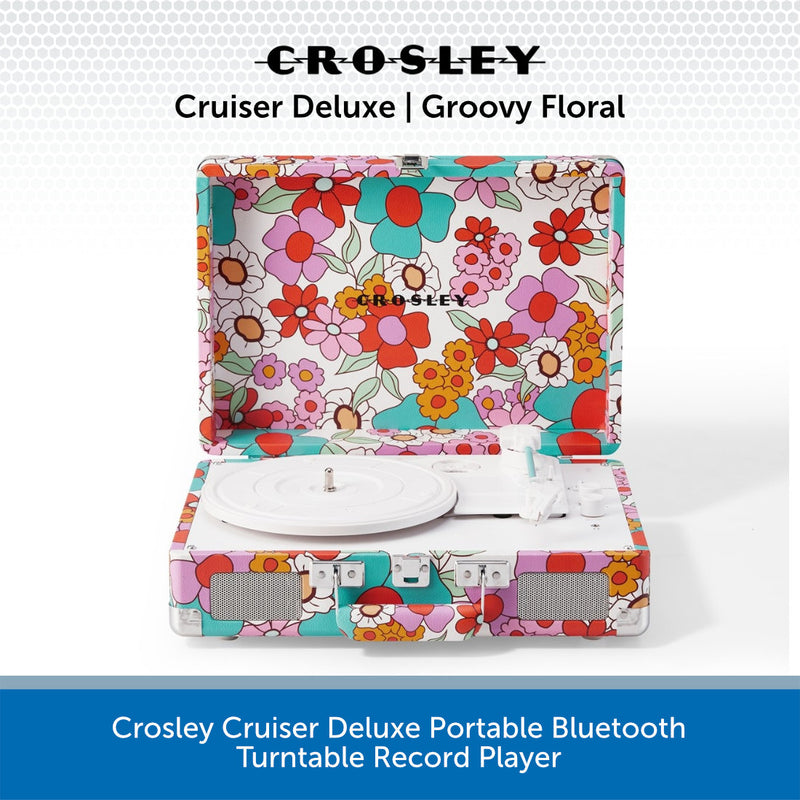 Crosley Cruiser Deluxe portable Bluetooth turntable record player in a retro floral print, shown open with the turntable platter visible inside. The product features a colorful pattern of pink, red, orange, yellow, and teal flowers on a white background, with a blue text banner at the bottom containing product details.