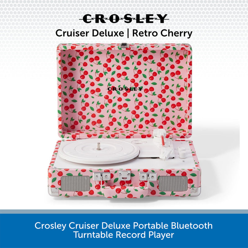 Crosley Cruiser Deluxe portable Bluetooth turntable record player in cherry print, shown open with the record platter and controls visible against a white background with a blue text banner at the bottom.