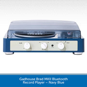Navy blue record player with white control knobs on a light gray background