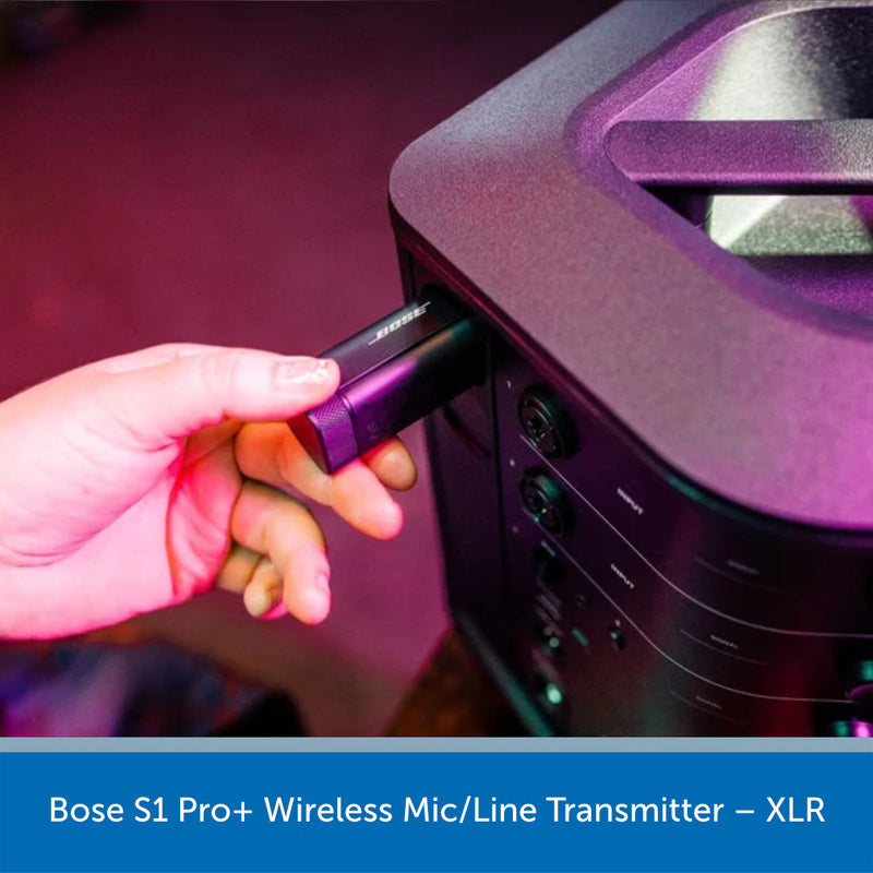 Hand plugging a wireless mic transmitter into a piece of audio equipment with Bose S1 Pro+ branding.