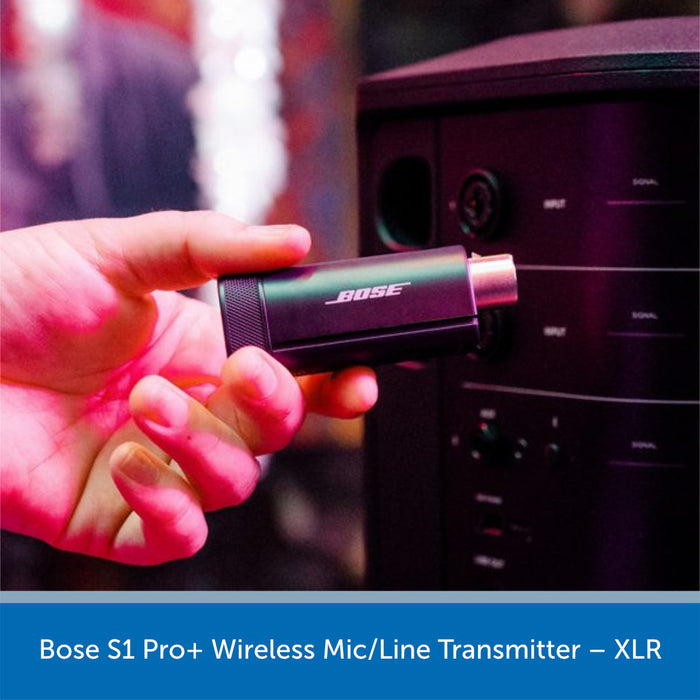 Hand holding a Bose S1 Pro+ Wireless Mic/Line Transmitter with a blurred background