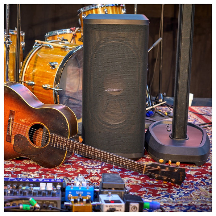 Guitar, amplifier, and drum set on a patterned rug