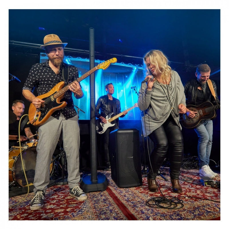 Band performing on stage with a blue light backdrop